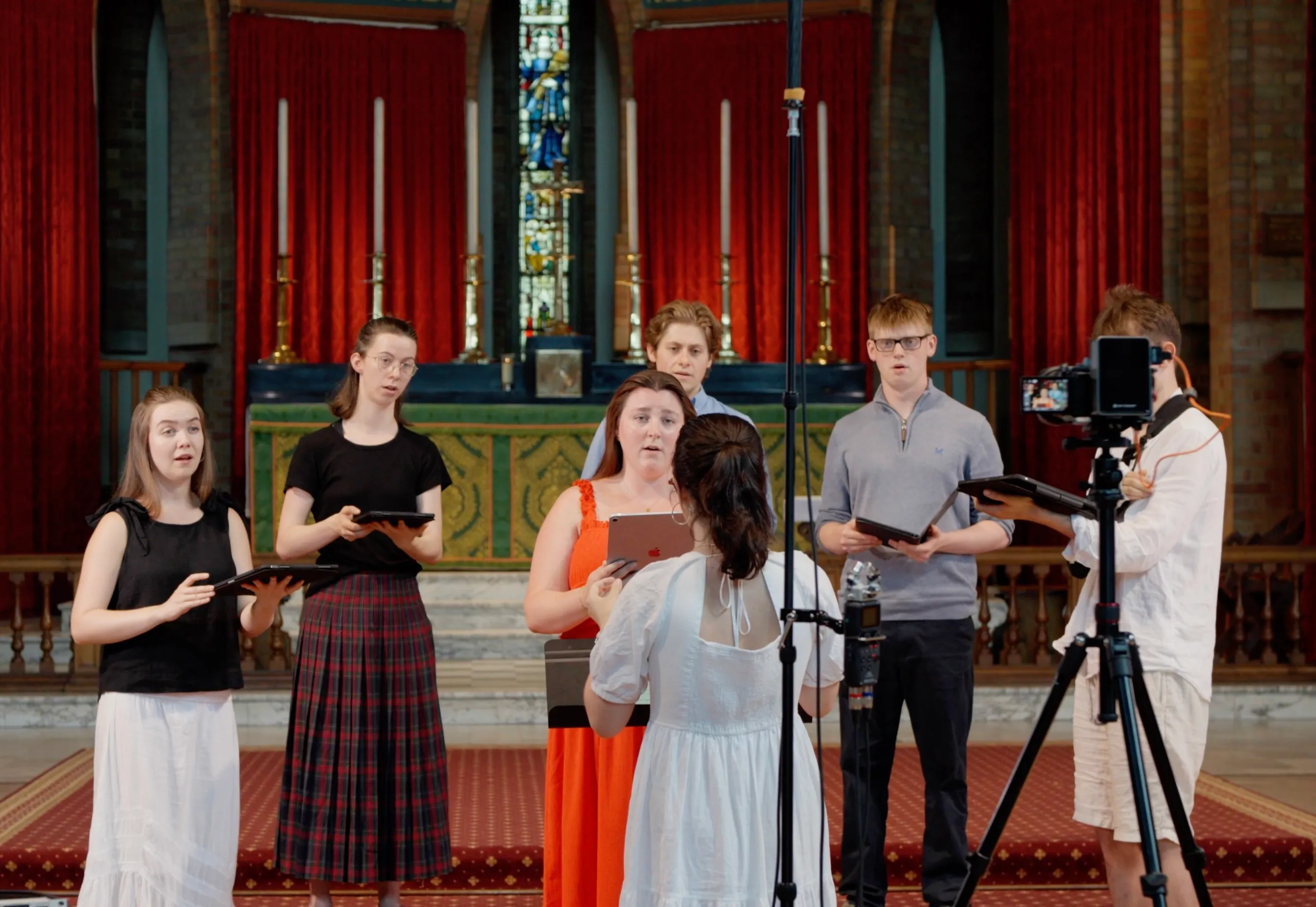 A soloist and small ensemble of Alma Consort singers being recorded on camera and microphone on location.